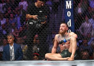 Conor McGregor of Ireland rests on the canvas after losing to UFC lightweight champion Khabib Nurmagomedov of Russia during UFC 229 at T-Mobile Arena Saturday, Oct. 6, 2018.
