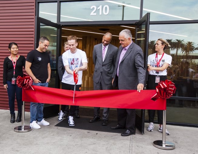 Andrew Modlin, co-founder and president of MedMen, cuts the ribbon ...
