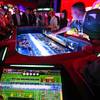 A player throws the dice on an electronic Roll to Win Craps table in the Aruze Gaming booth at the Global Gaming Expo at the Sands Expo Center Wednesday, Oct. 10, 2018.