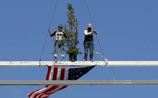 Iron workers pose on the steel beam during a topping out ceremony at the Las Vegas Ballpark in Summerlin Thursday, Oct. 11, 2018. The stadium is scheduled to be completed before the team's season opener on April 9, 2019.