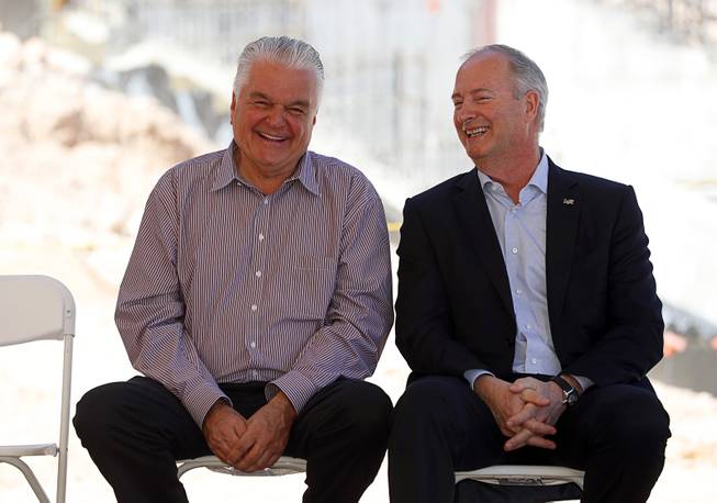 Clark County Commission Chairman Steve Sisolak, left, and Steve Hill, CEO of Las Vegas Convention and Visitors Authority, laugh during a topping out ceremony at the Las Vegas Ballpark in Summerlin Thursday, Oct. 11, 2018. The stadium is scheduled to be completed before the team's season opener on April 9, 2019.