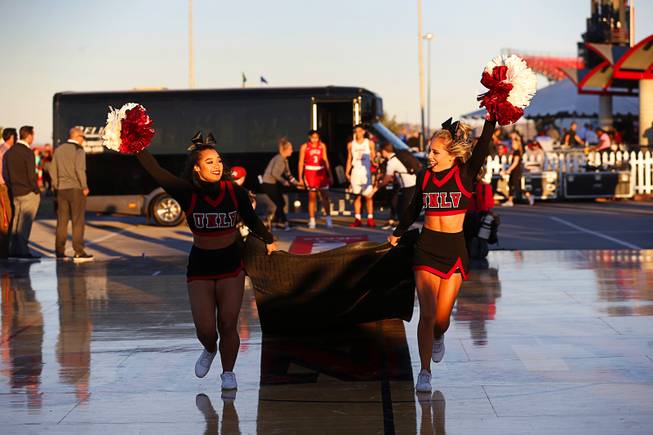 Cheerleaders bring out a red carpet  for UNLV Runnin' Rebels and Lady Rebels during an exhibition in the parking lot of Sam Boyd Stadium before the UNLV-Air Force football game Friday, Oct. 19, 2018.