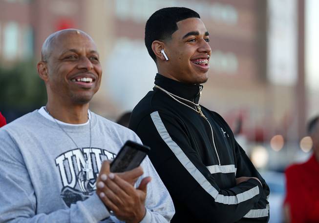Julian Strawther, right, and his father watch an exhibition with the UNLV Runnin' Rebels and Lady Rebels in the parking lot of Sam Boyd Stadium before the UNLV-Air Force football game Friday, Oct. 19, 2018.