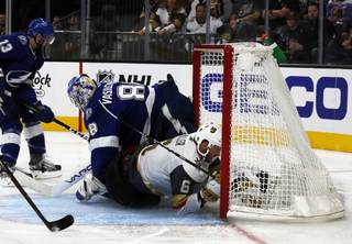Vegas Golden Knights defenseman Colin Miller (6) slides past Tampa Bay Lightning goaltender Andrei Vasilevskiy (88) and into the net during the second period of their game at T-Mobile Arena Friday, Oct. 26, 2018. 