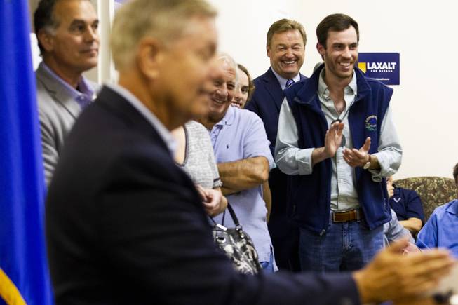 Incumbent Republican Sen. Dean Heller, back, reacts to Sen. Lindsey Graham, R-S.C., speech during a campaign office event, Friday, Oct. 26, 2018.