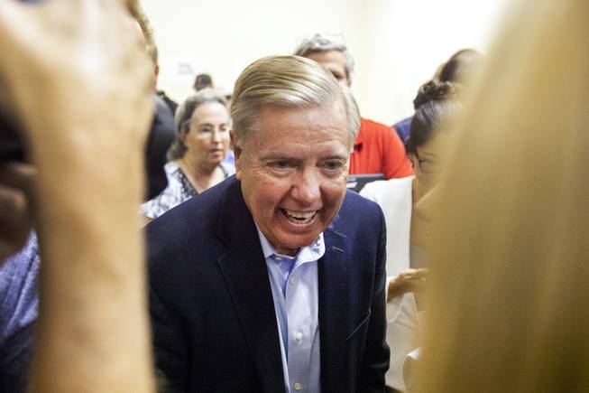 Sen. Lindsey Graham, R-S.C., greets attendees following a campaign office event, Friday, Oct. 26, 2018.