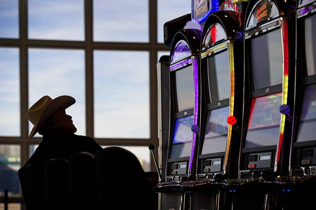 A passenger plays a slot machine while waiting for flight in a newly renovated A-Gates cluster building at McCarran International Airport Thursday, Nov. 1, 2018.