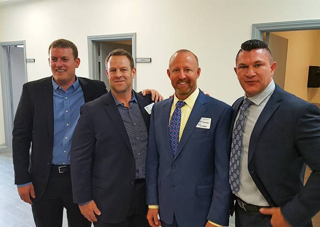 CrossRoads of Southern Nevada board members Jason Horwitz and J. J. Bell, along with Jeff Iverson, one of the founders, and board member Will McNeil pose for a photo after a ribbon-cutting ceremony on Thursday, Nov. 1, 2018, at the new facility, which will offer mental health and substance abuse recovery services.