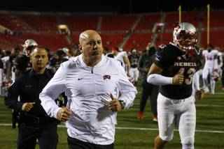 UNLV Rebels head coach Tony Sanchez leaves the field with players after a 3-48 loss to Fresno State Bulldogs at Sam Boyd Stadium Saturday, Nov. 3, 2018.