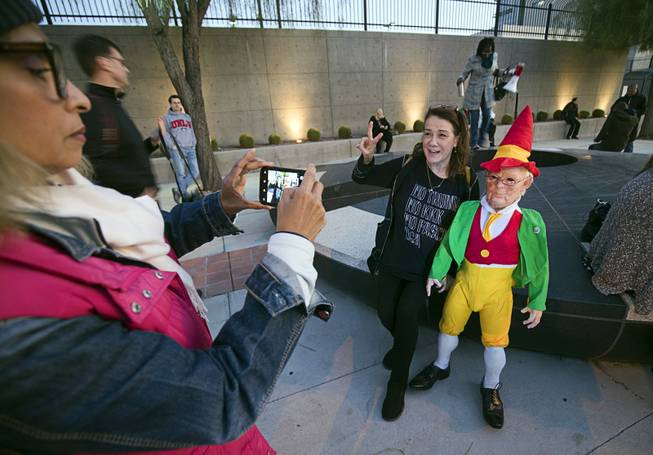 Valerie Carpenter has her photo taken with an elvish Donald Trump, created by artist Joshua "Ginger" Monroe, during a protest in front of the Lloyd D. George Federal Building in downtown Las Vegas Thursday, Nov. 8, 2018. Following the firing of U.S. Attorney General Jeff Sessions, activists are asking that the investigation into alleged Russian interference in the 2016 elections is protected.