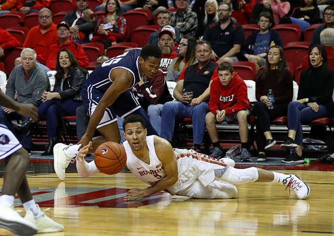 UNLV Rebels guard Noah Robotham (5) slips in front of Loyola Marymount Lions guard Jeffery McClendon (25) during a game at the Thomas & Mack Center Saturday, Nov. 10, 2018.