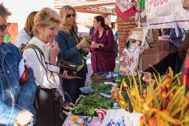 Commissioner Chris Giunchigliani looks to purchase some fresh greens from students at Foothills Montessori School during the Student Farmers Market at the Clark County Government Center, Thursday Nov. 8, 2018.