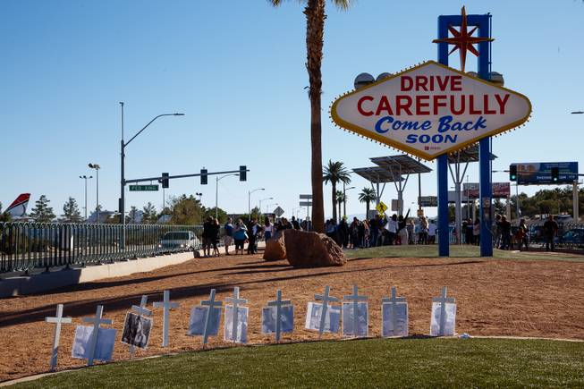 Memorial crosses for victims of the Thousand Oaks shooting massacre are seen near the Welcome to Fabulous Las Vegas sign, Monday, Nov. 12, 2018. Twelve people were killed when a gunman opened fire at a bar in Thousand Oaks, California.