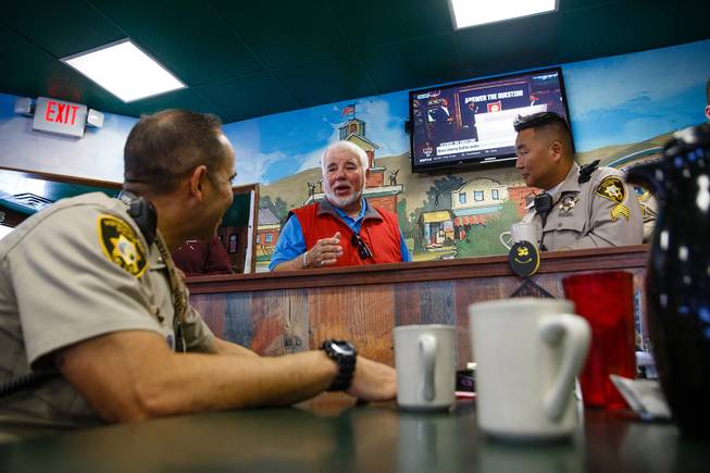 From left, Metro Police Lt. Frank Fama, Vaughan Brown of Texas and Officer Josh Younger discuss concealed weapon laws during a meet-and-greet event called Coffee with a Cop at the Egg & I, Wednesday, Nov. 14, 2018.