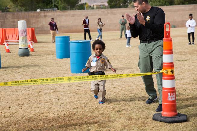 4-year-old Jon'tel Thomas runs trough an obstacle course at the Las Vegas Metropolitan Police academy, Friday Nov. 16, 2018.
