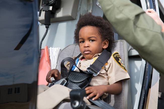 4-year-old Jon'tel Thomas sits in the pilot's seat of an LVMPD helicopter as he becomes an honorary police officer for the day with help from the Make a Wish Foundation of Southern Nevada, Friday Nov. 16, 2018., Friday Nov. 16, 2018.