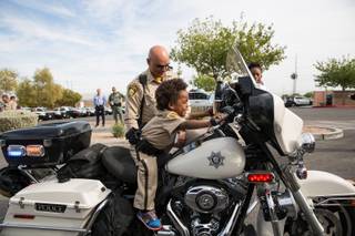 4-year-old Jon'tel Thomas sits on an LVMPD motorcycle as he becomes an honorary police officer for the day with help from the Make a Wish Foundation of Southern Nevada, Friday Nov. 16, 2018., Friday Nov. 16, 2018.