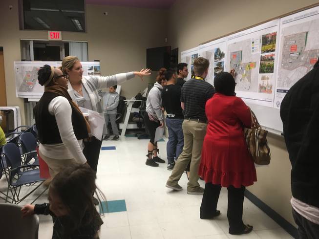 Las Vegas community members examine the maps of proposed improvements to downtown parks at a public meeting Wednesday at the Municipal Pool.