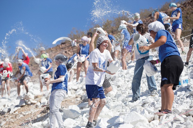 Students paint a B on the side a mountain near the school.
