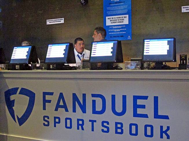 This July 14, 2018 file photo shows workers at the FanDuel sports book at the Meadowlands Racetrack in East Rutherford, N.J., preparing to take bets moments before it opened.