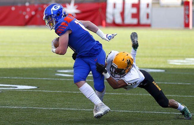 Bishop Gorman's strong safety Travis Meyer (17) is tackled by ...