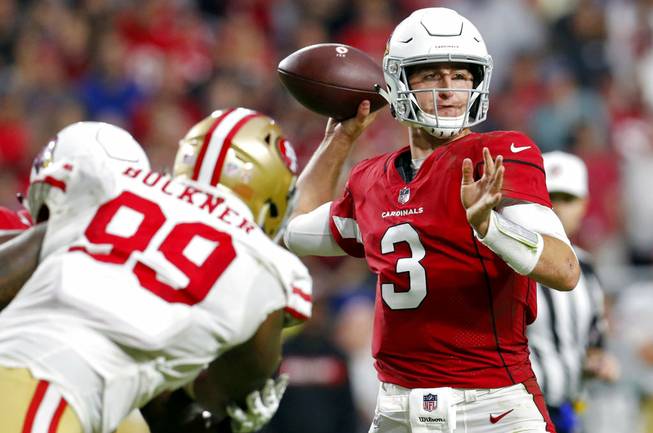 In this Sunday, Oct. 28, 2018, file photo, Arizona Cardinals quarterback Josh Rosen throws as San Francisco 49ers defensive tackle DeForest Buckner pursues during a game in Glendale, Ariz. Embracing his Judaism, Rosen has developed a celebration dance called “The Hebrew Hammer” in the hopes that he can be a role model for Jewish fans and also a leader in a locker room that includes a variety of races and religions. 