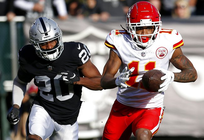 Kansas City Chiefs wide receiver Demarcus Robinson (11) runs in front of Oakland Raiders cornerback Daryl Worley (20) during the first half of an NFL football game in Oakland, Calif., Sunday, Dec. 2, 2018. 

