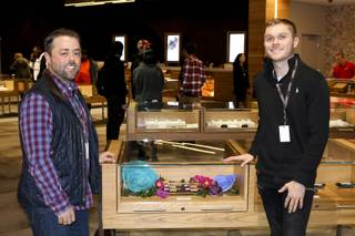 Hunter & Leaf founders Jacob Silverstein (left) and Zachary LoBello (right) pose in front of a display case of their products at Planet 13 dispensary on December 3, 2018 