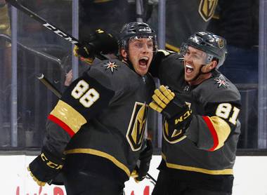 Vegas Golden Knights center Jonathan Marchessault, right, celebrates after defenseman Nate Schmidt (88) scored against the Washington Capitals during the third period of an NHL hockey game Tuesday, Dec. 4, 2018, in Las Vegas.