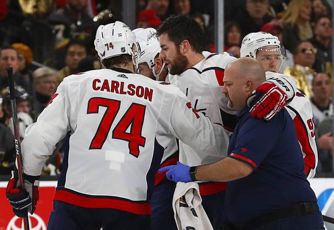 Washington Capitals right wing Tom Wilson (43) is helped from the ice after a hard hit from Vegas Golden Knights right wing Ryan Reaves at T-Mobile Arena Tuesday, Dec. 4, 2018. Reaves was ejected from the game after the hit. 