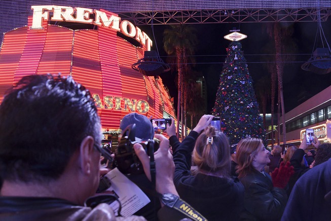 People turn to look at the lit tree during the ...