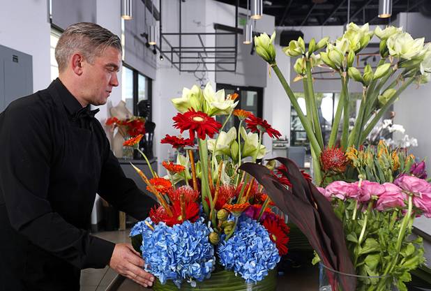 Steven Stewart-Clark works on a floral display at Stinko's, a florist and events business in the Arts District, 1029 S. Main St., Wednesday, Dec. 12, 2018.