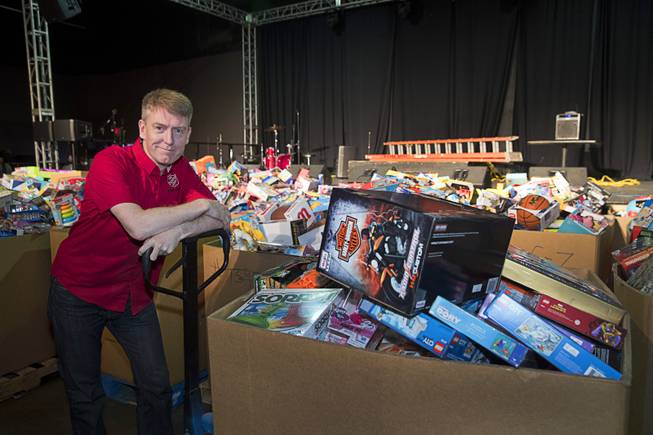 Simon Tait, a volunteer from the Bay Area, poses by boxes of toys during the Salvation Army's Christmas Angel program at the Silver Nugget Events Center in North Las Vegas Friday, Dec. 14, 2018.