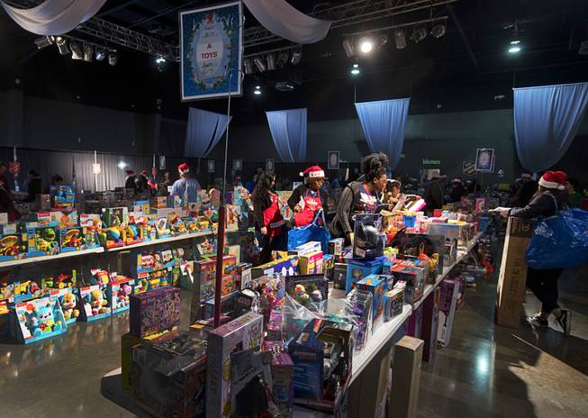 Tables are stacked with toys during the Salvation Army's Christmas Angel program at the Silver Nugget Events Center in North Las Vegas Friday, Dec. 14, 2018.