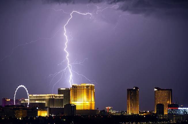 Lightning flashes behind the Palazzo and Trump International Hotel as ...