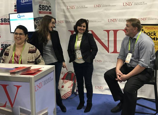Zach Miles, right, UNLV's associate vice president for economic development, talks with fellow university staffers at a CES booth on Thursday, Jan. 10, 2019.