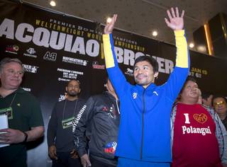 WBA welterweight champion Manny Pacquiao of the Philippines waves to fans in the MGM Grand  lobby during his 
