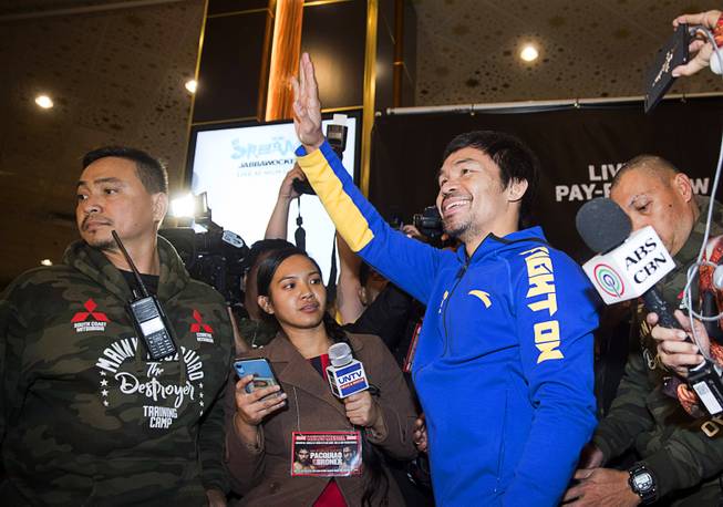 WBA welterweight champion Manny Pacquiao of the Philippines waves to fans in the MGM Grand  lobby during his "Grand Arrival"  Tuesday, Jan. 15, 2019. Pacquiao will defend his WBA title agains Adrien Broner of Cincinnati, Ohio at the MGM Grand Garden Arena  on Saturday.