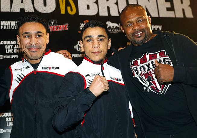 Bantamweight boxer Nordine Oubaali, center, of France  poses with Roy Jones Jr., right, during his "Grand Arrival" in the MGM Grand lobby in Las Vegas Tuesday, Jan 15, 2019. Warren will face Nordine Oubaali of France for a vacant WBC title at the MGM Grand Garden Arena on Saturday.