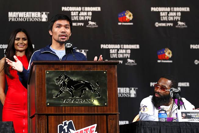 Challenger Adrien Broner, right, of Cincinnati, Ohio, listens to WBA welterweight champion Manny Pacquiao of the Philippines during a news conference at the MGM Grand Wednesday, Jan. 16, 2019. Pacquiao will defend his WBA title against Broner at the MGM Grand Garden Arena Saturday.