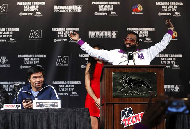WBA welterweight champion Manny Pacquiao, left, of the Philippines, waits as challenger Adrien Broner of Cincinnati, Ohio stretches before speaking at a final news conference in the MGM Grand Wednesday, Jan. 16, 2019. Pacquiao will defend his WBA title against Broner at the MGM Grand Garden Arena Saturday.