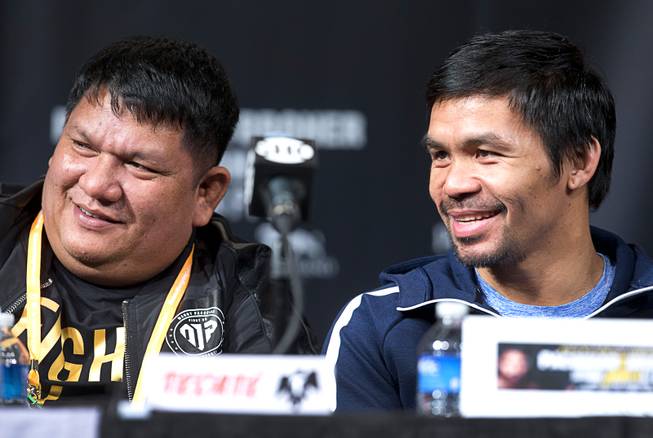 WBA welterweight champion Manny Pacquiao, right, of the Philippines, and trainer Buboy Fernandez attend a final news conference at the MGM Grand Wednesday, Jan. 16, 2019. Pacquiao will defend his WBA title against Adrien Broner of Cincinnati, Ohio at the MGM Grand Garden Arena Saturday.