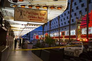 An investigator works a crime scene where a man was fatally shot by a security guard in front of Binion's, downtown, Thursday, Jan. 17, 2019.