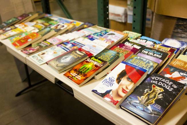 A table display of donated books is on view during a tour by Carlos Santana and his Milagro Foundation staff at the Spread the Word Nevada offices and warehouse in Henderson, NV, Thursday, Jan. 17, 2019. The Milagro Foundation made a donation to Spread the Word, which will provide about 15,000 books to 57 schools across Southern Nevada.