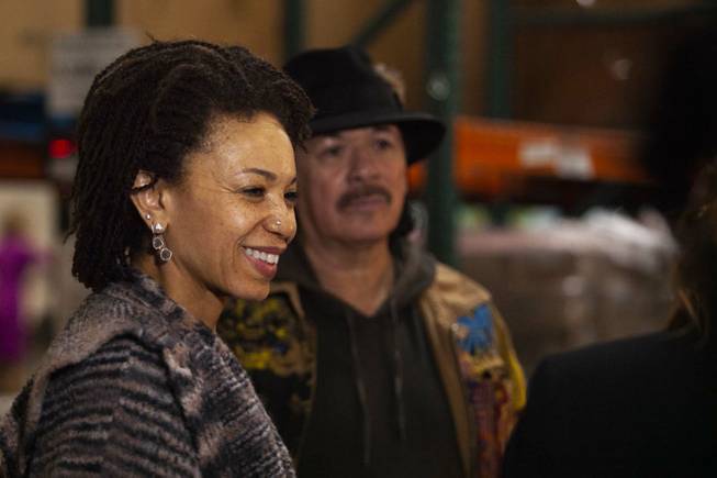 Carlos Santana, back, and his wife Cindy Blackman, left, take a tour of the Spread the Word Nevada offices and warehouse in Henderson, NV, Thursday, Jan. 17, 2019. Santana's Milagro Foundation made a donation to Spread the Word, which will provide about 15,000 books to 57 schools across Southern Nevada.