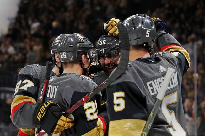 The Vegas Golden Knights celebrate after scoring against the Pittsburgh Penguins during the 1st period of an NHL hockey game at T-Mobile arena Saturday, Jan. 19, 2019.