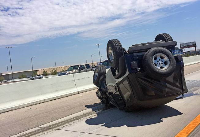 A vehicle is seen overturned after an accident on the 215 Beltway near Buffalo Drive.