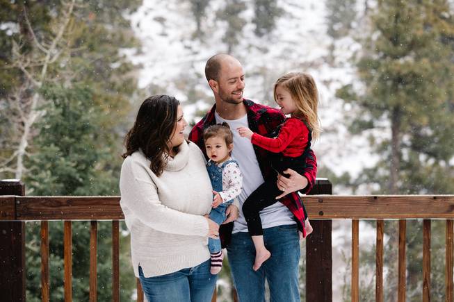 From left, Katie Corr, Rylee Corr, 1, Steven Corr, and Peyton Corr, 3, pose for a photo in the backyard of their Mount Charleston home Monday, Jan. 21, 2019.
