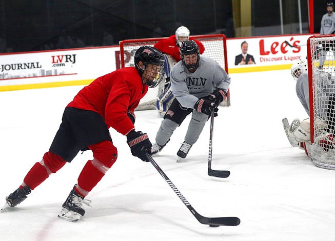 Joseph Kaszupski, left, controls the puck during UNLV hockey practice ...
