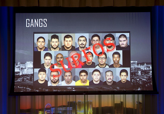 A slide displays mug shots of gang members during Sheriff ...